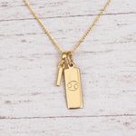 Gold Initial and Cancer Zodiac Necklace with letter I pendant on light wood