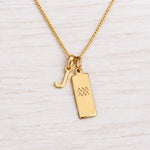 Gold Initial and Aquarius Zodiac Necklace with letter J pendant on light wood