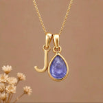 Gold Initial j and December Birthstone natural Tanzanite Necklace on a warm background