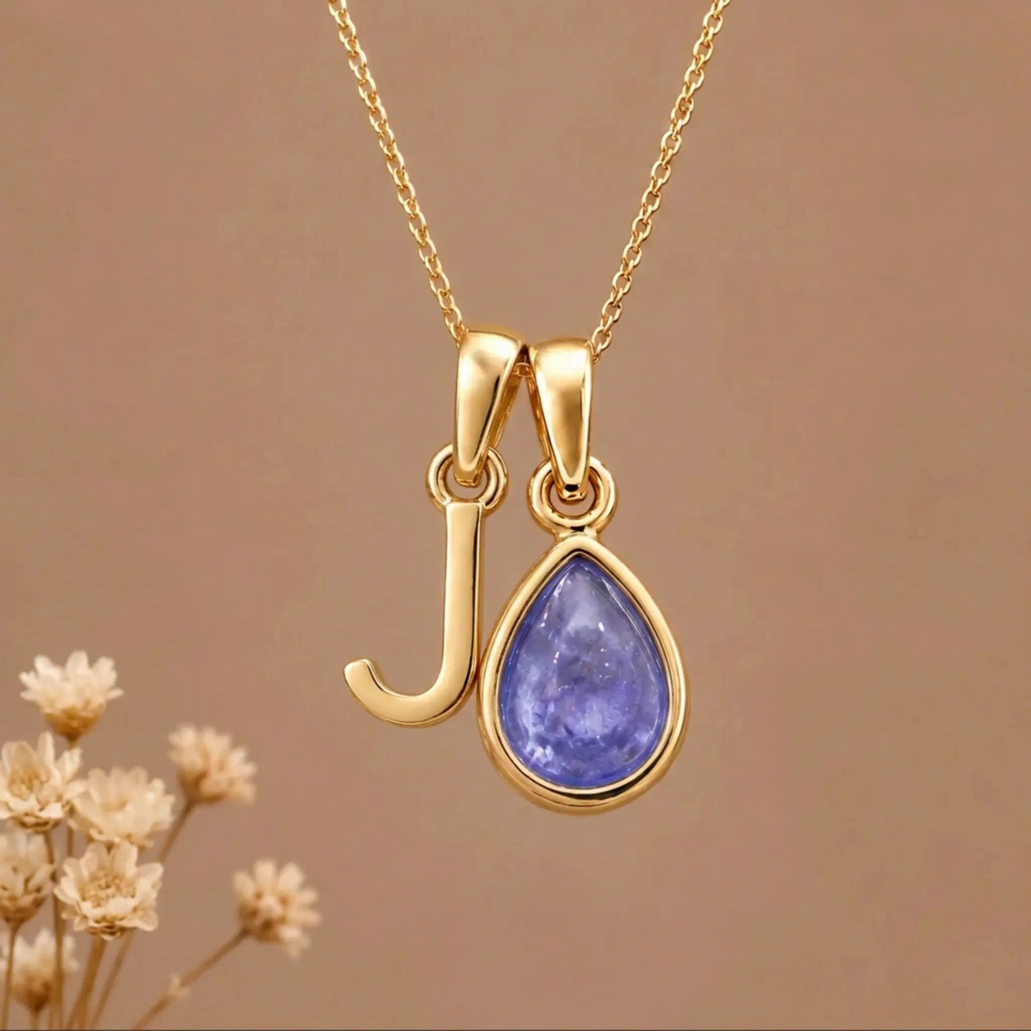 Gold Initial j and December Birthstone natural Tanzanite Necklace on a warm background