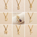 Collage of gold fine chain necklaces with various letters R to Y on a beige background as gold initial options for the January birthstone garnet necklace