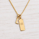 Gold Initial and Aquarius Zodiac Necklace with letter L pendant on light wood