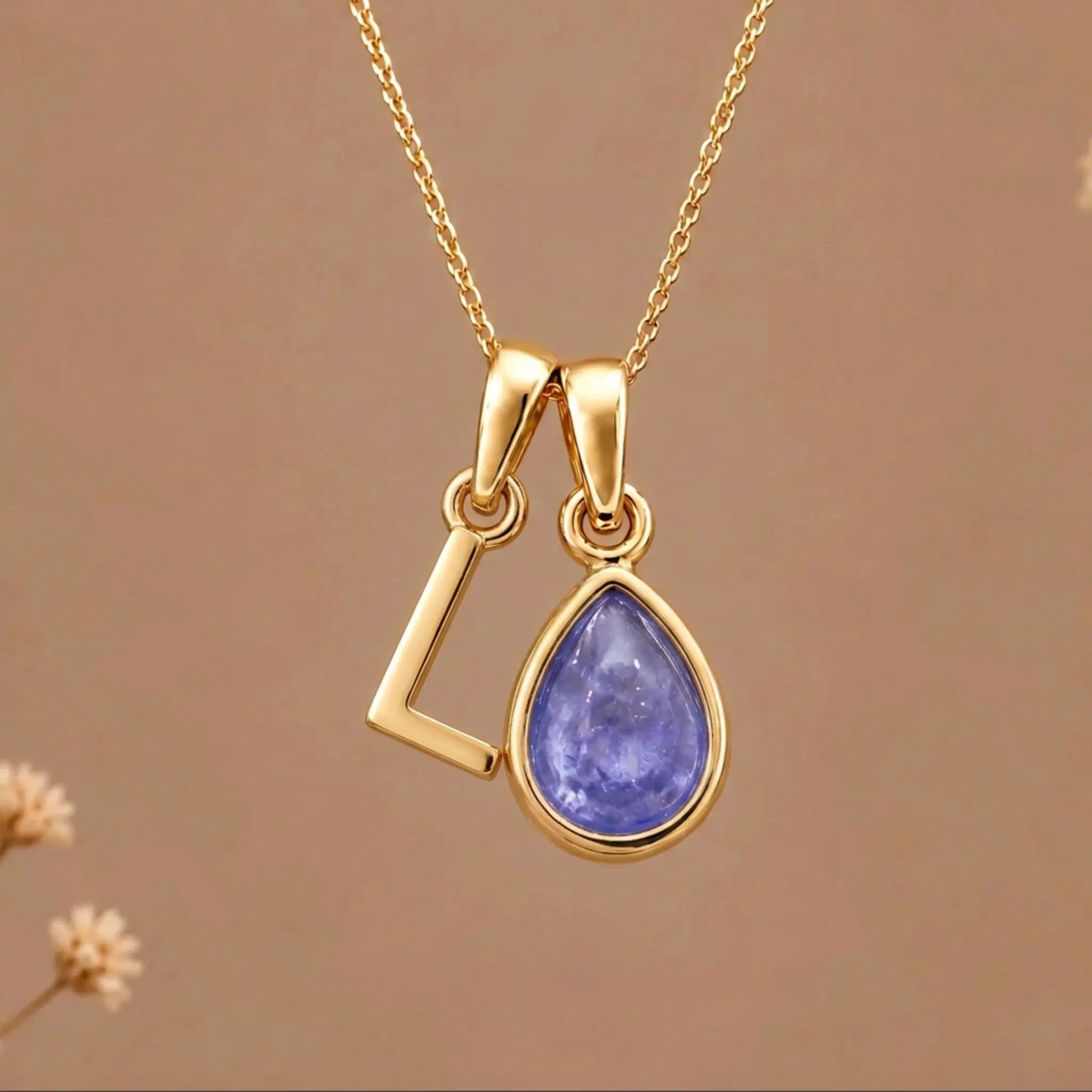 Gold Initial l and December Birthstone natural Tanzanite Necklace on a warm background