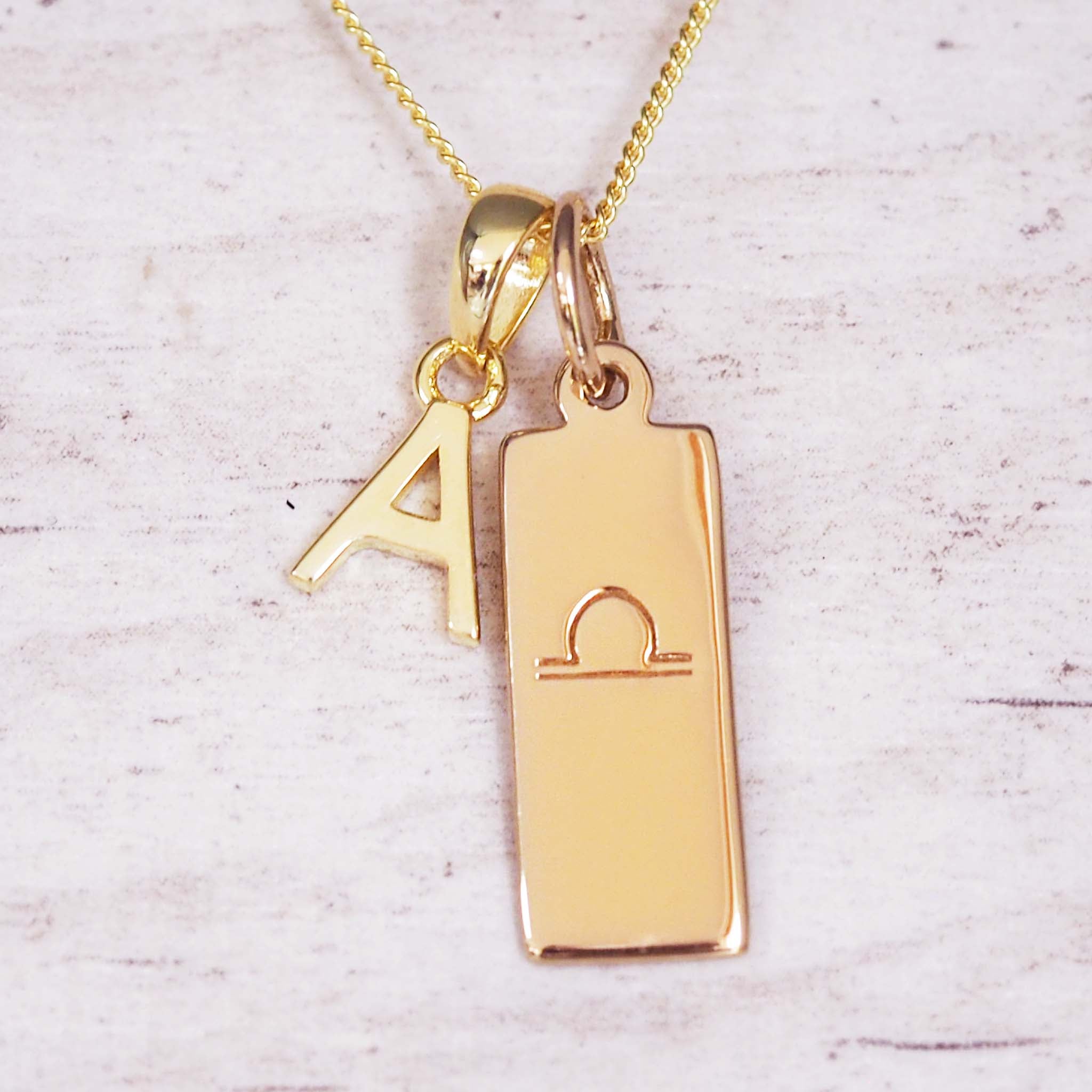 Fine Gold Chain double pendant necklace with a uppercase letter 'A' and a rectangular pendant with a libra zodiac glyph symbo