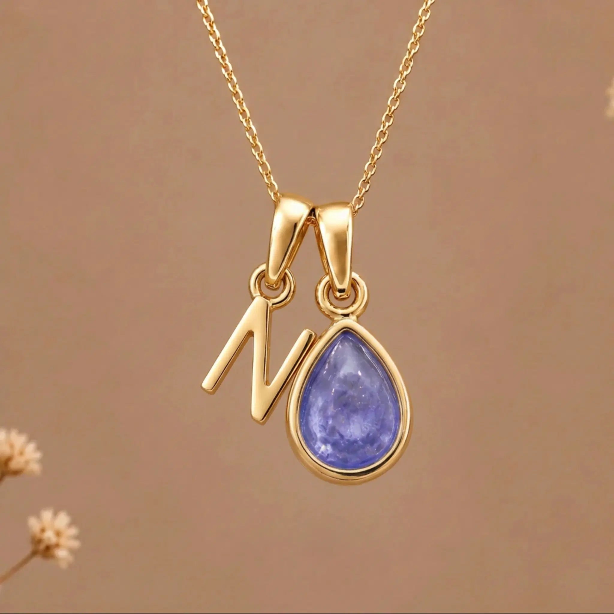 Gold Initial N and December Birthstone natural Tanzanite Necklace on a warm background