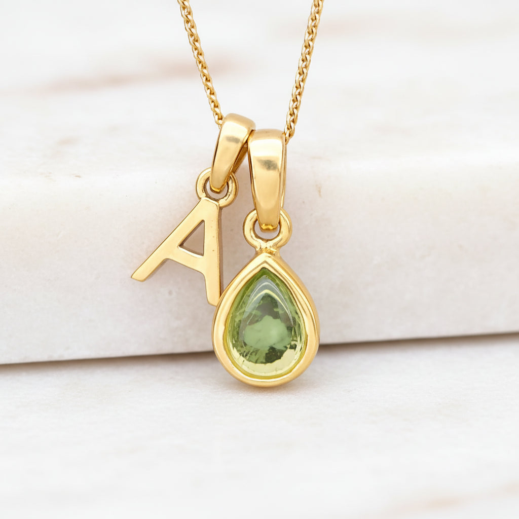 Personalised Gold August Birthstone necklace with a natural peridot pear-shaped pendant and 'A' initial pendant