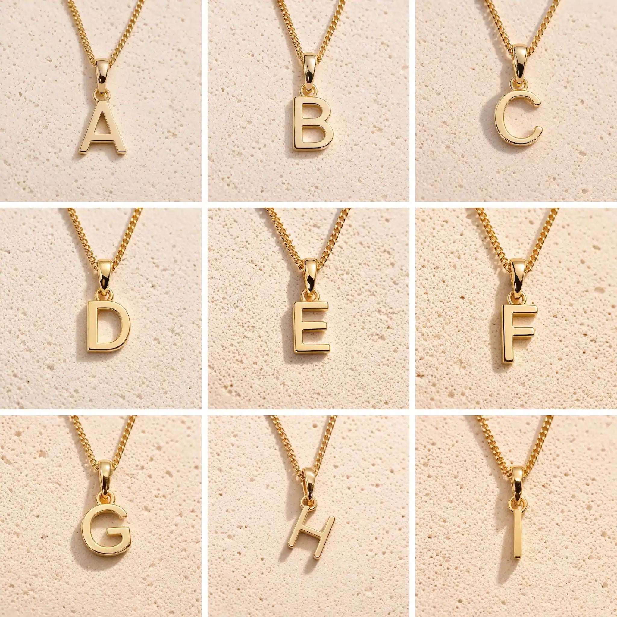 Grid of gold uppercase initial letter charms A to I on fine cable chains, showing personalised initial options for the Libra zodiac double pendant necklace.