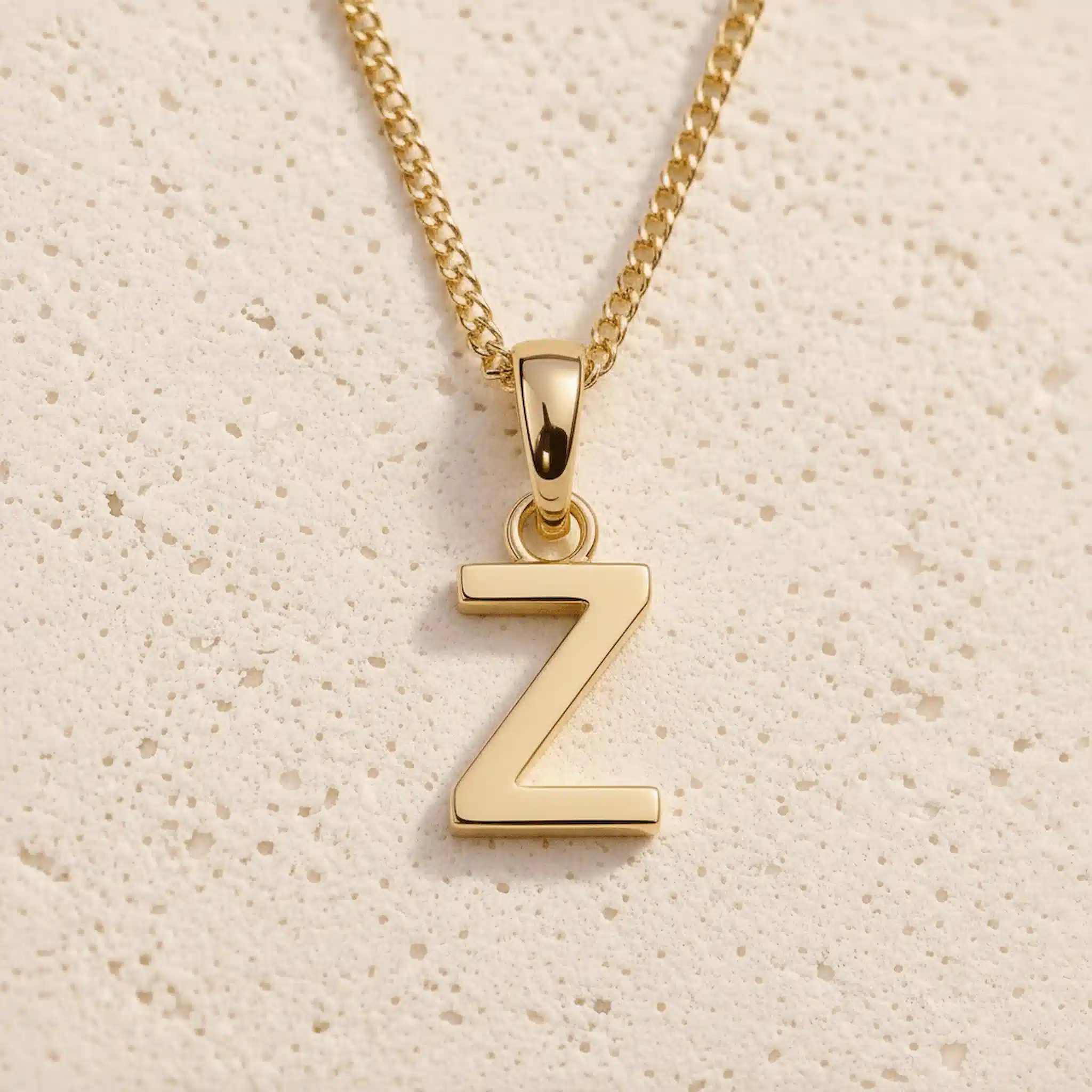 Close-up of gold initial necklace with a  Z letter charm on a fine gold chain; a letter charm option to personalise April Birthstone Necklaces