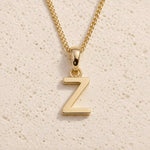Close-up of gold initial necklace with a  Z letter charm on a fine gold chain; a letter charm option to personalise Virgo Zodiac Necklace