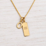 Gold Initial and Aquarius Zodiac Necklace with letter O pendant on light wood