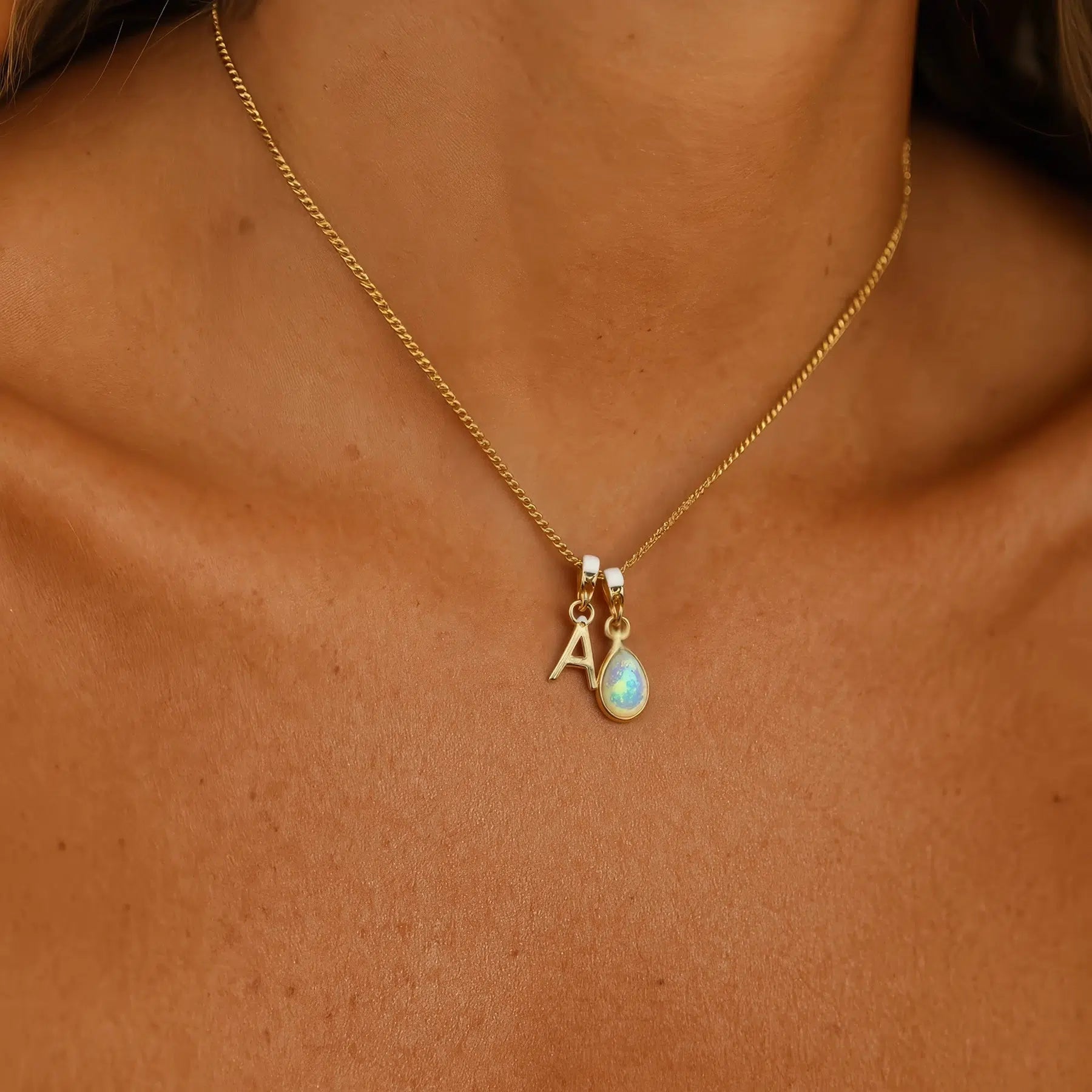 gold initial and october birthstone opal pendant necklace worn