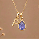 Gold Initial P and December Birthstone natural Tanzanite Necklace on a warm background
