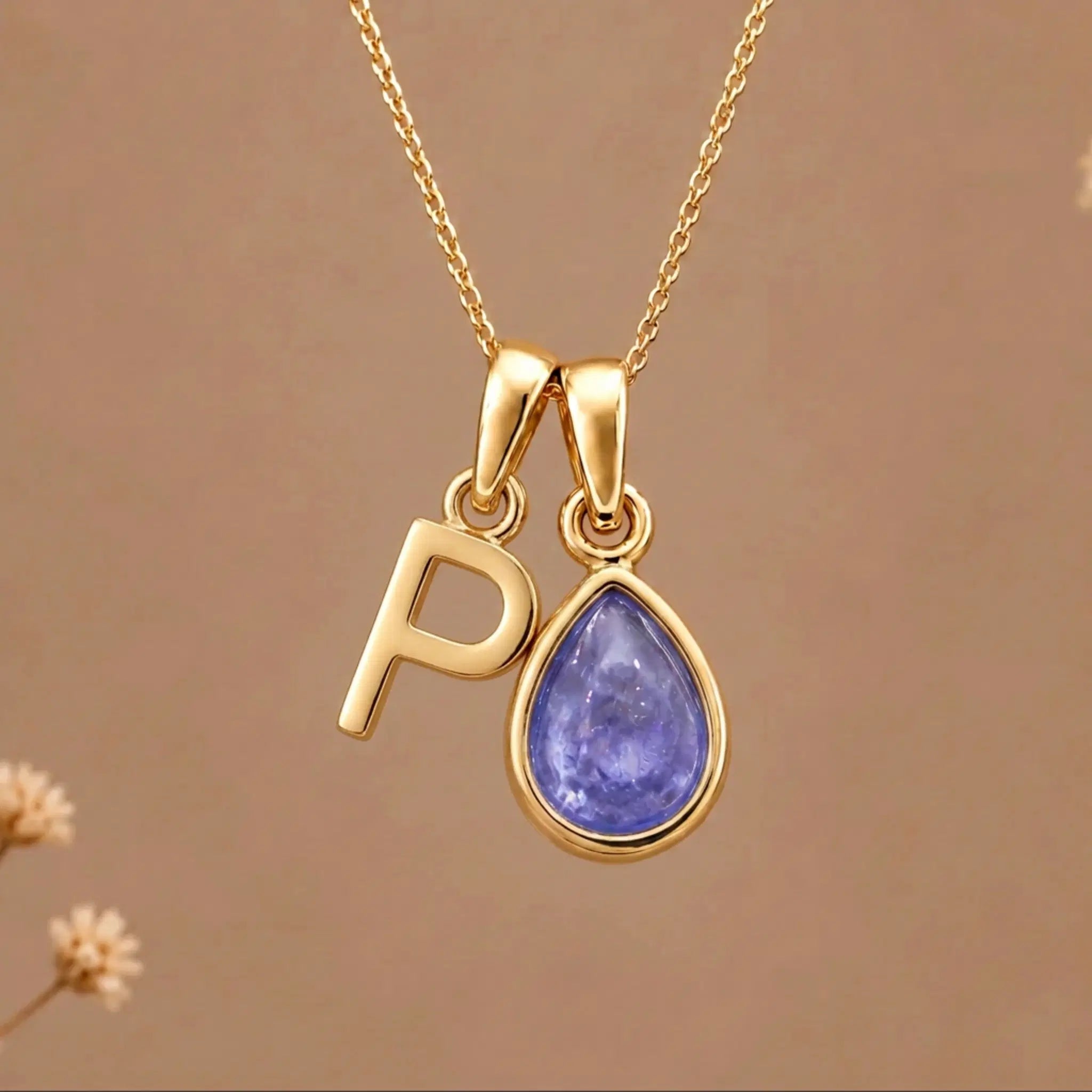 Gold Initial P and December Birthstone natural Tanzanite Necklace on a warm background