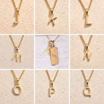 3x3 grid showing personalised gold initial necklace options J, K, L, M, N, O, P and Q, with the centre image featuring the Pisces zodiac double-pendant necklace with an uppercase A charm and engraved rectangular bar tag on a fine cable chain.