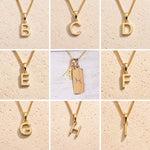 3x3 grid showing personalised gold initial necklace options B, C, D, E, F, G, H and I, with the centre image featuring the Pisces zodiac double-pendant necklace with an uppercase A charm and engraved rectangular bar tag on a fine cable chain.