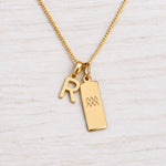 Gold Initial and Aquarius Zodiac Necklace with letter R pendant on light wood