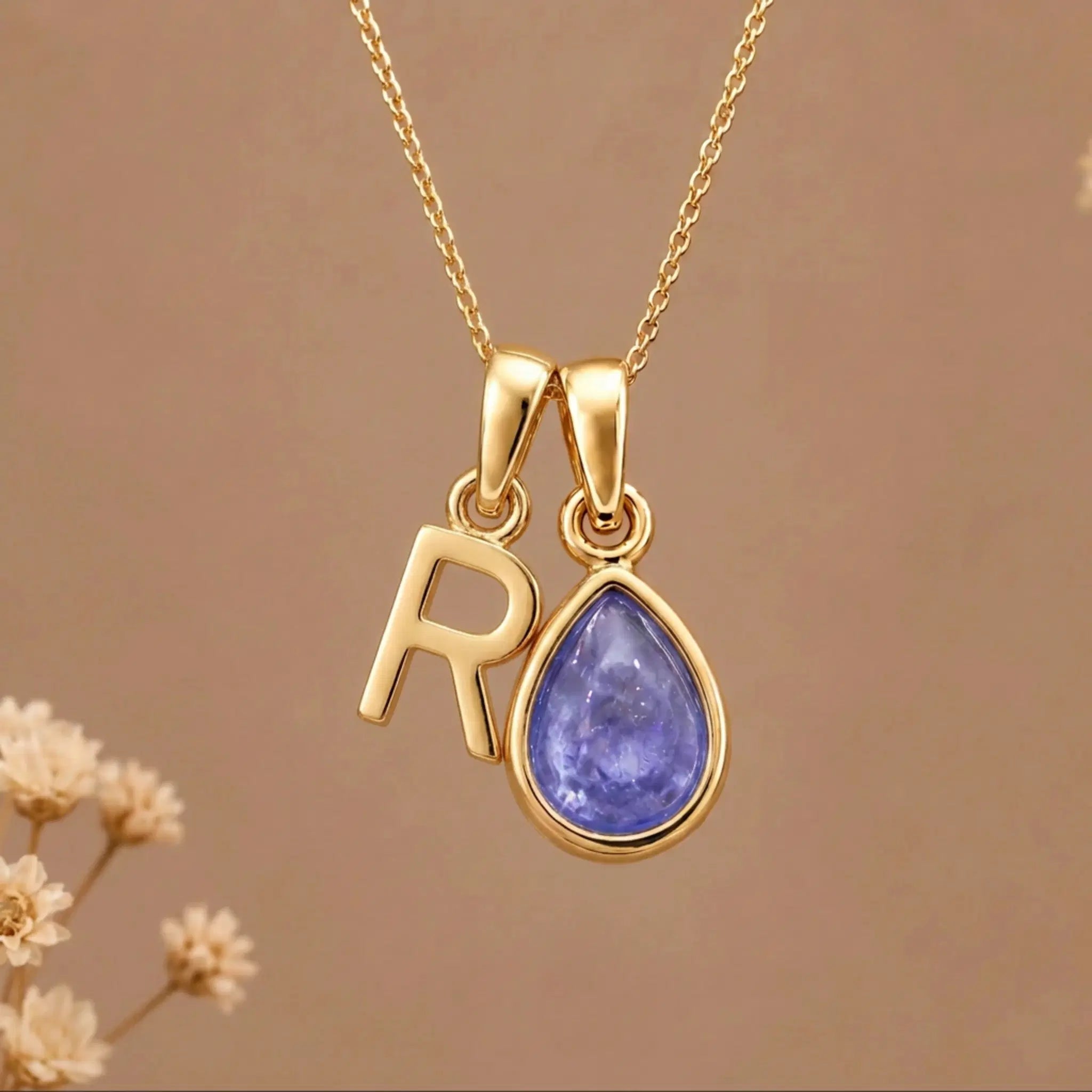 Gold Initial R and December Birthstone natural Tanzanite Necklace on a warm background