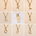Gold necklaces with letters J to Q on a beige background as letter charm options for Gold Sagittarius Zodiac Star Sign Necklace with Gold A Initial Sagittarius Zodiac Necklace in the middle