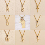 Gold necklaces with letters R to Y on a beige background as letter charm options for Gold Sagittarius Zodiac Star Sign Necklace with Gold A Initial Sagittarius Zodiac Necklace in the middle
