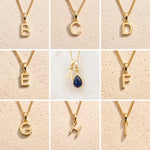 Grid of Gold Fine Chain Necklaces with uppercase letter pendants B, C, D, E, A, F, G, H, I on a beige background, as personalised gold initial options to add to a September Birthstone Sapphire Necklace.