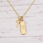 Gold Initial and Cancer Zodiac Necklace with letter T pendant on light wood