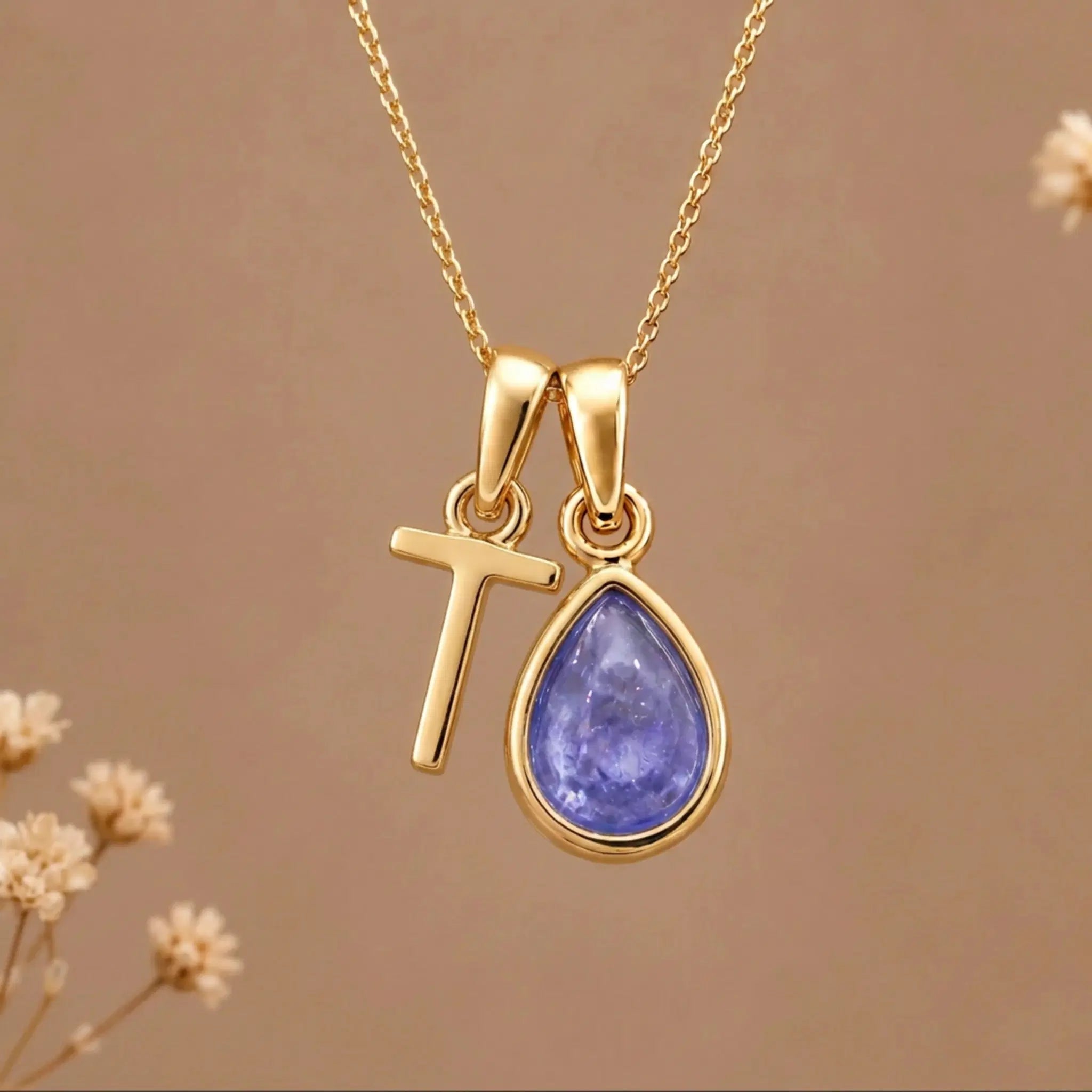Gold Initial T and December Birthstone natural Tanzanite Necklace on a warm background