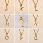 Collage of fine gold chain necklaces with uppercase gold letter J, K, L, M, N, O, P, Q, A pendants on a beige background as personalised gold initial pendant options for Taurus Zodiac Necklace.