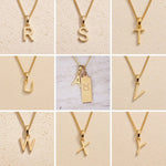 Collage of fine gold chain necklaces with uppercase gold letter R, S, T, U, V, W, Y, Z, A pendants on a beige background as personalised gold initial pendant options for Taurus Zodiac Necklace.
