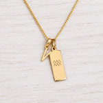 Gold Initial and Aquarius Zodiac Necklace with letter V pendant on light wood