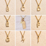 Gold necklaces with letter pendants on a beige background showing the gold initial options a, b, c, d, e, f, g, h, i for the personalised virgo zodiac necklace