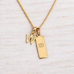 Gold Initial and Aquarius Zodiac Necklace with letter W pendant on light wood