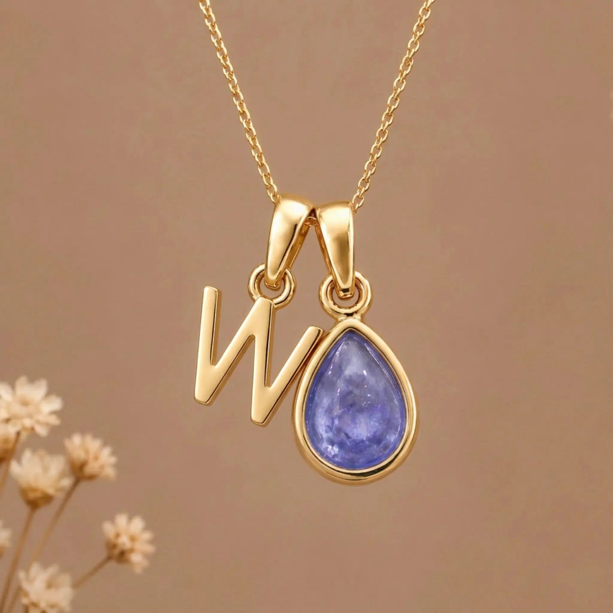 Gold Initial W and December Birthstone natural Tanzanite Necklace on a warm background