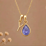 Gold Initial Y and December Birthstone natural Tanzanite Necklace on a warm background