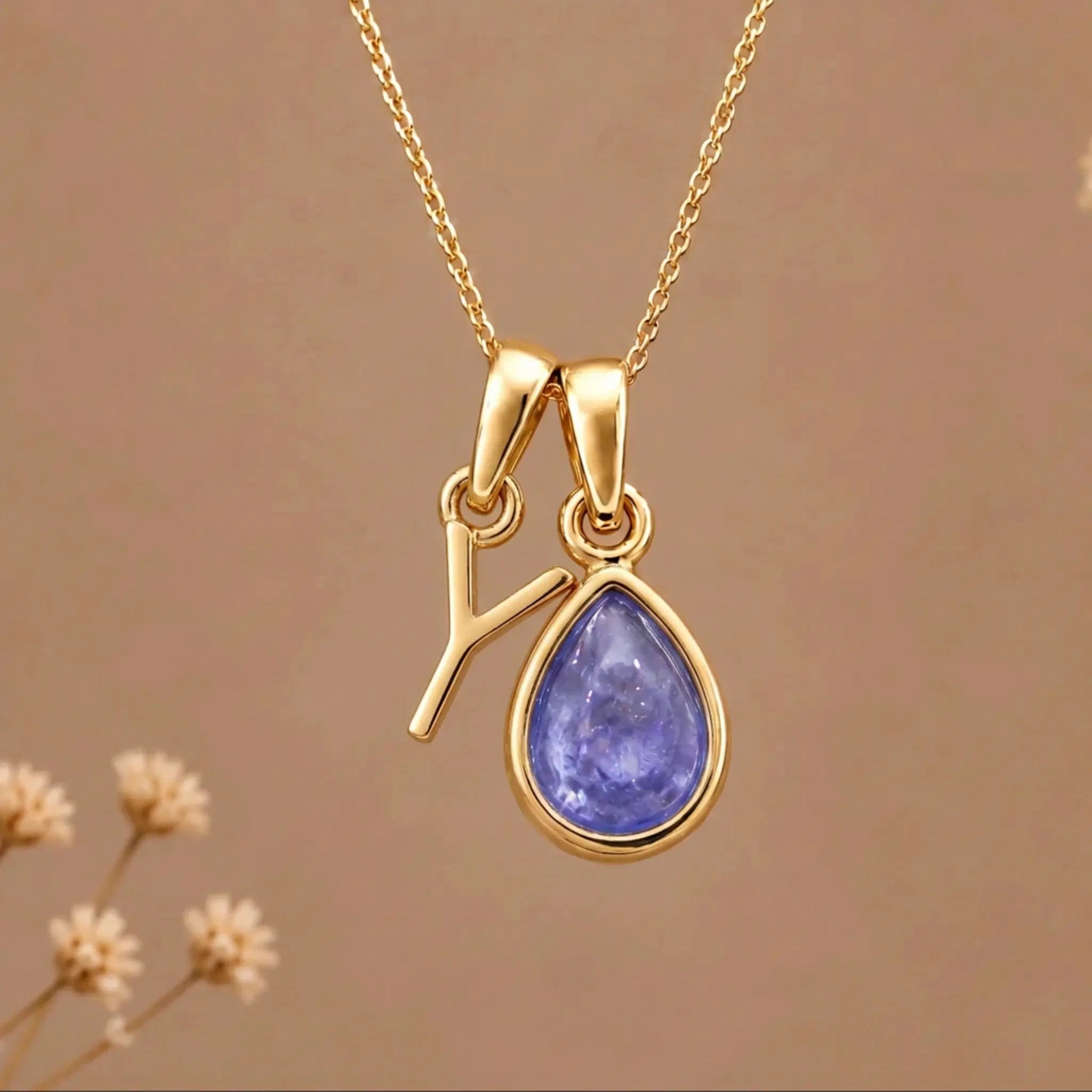 Gold Initial Y and December Birthstone natural Tanzanite Necklace on a warm background