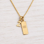 Gold Initial and Aquarius Zodiac Necklace with letter Z pendant on light wood