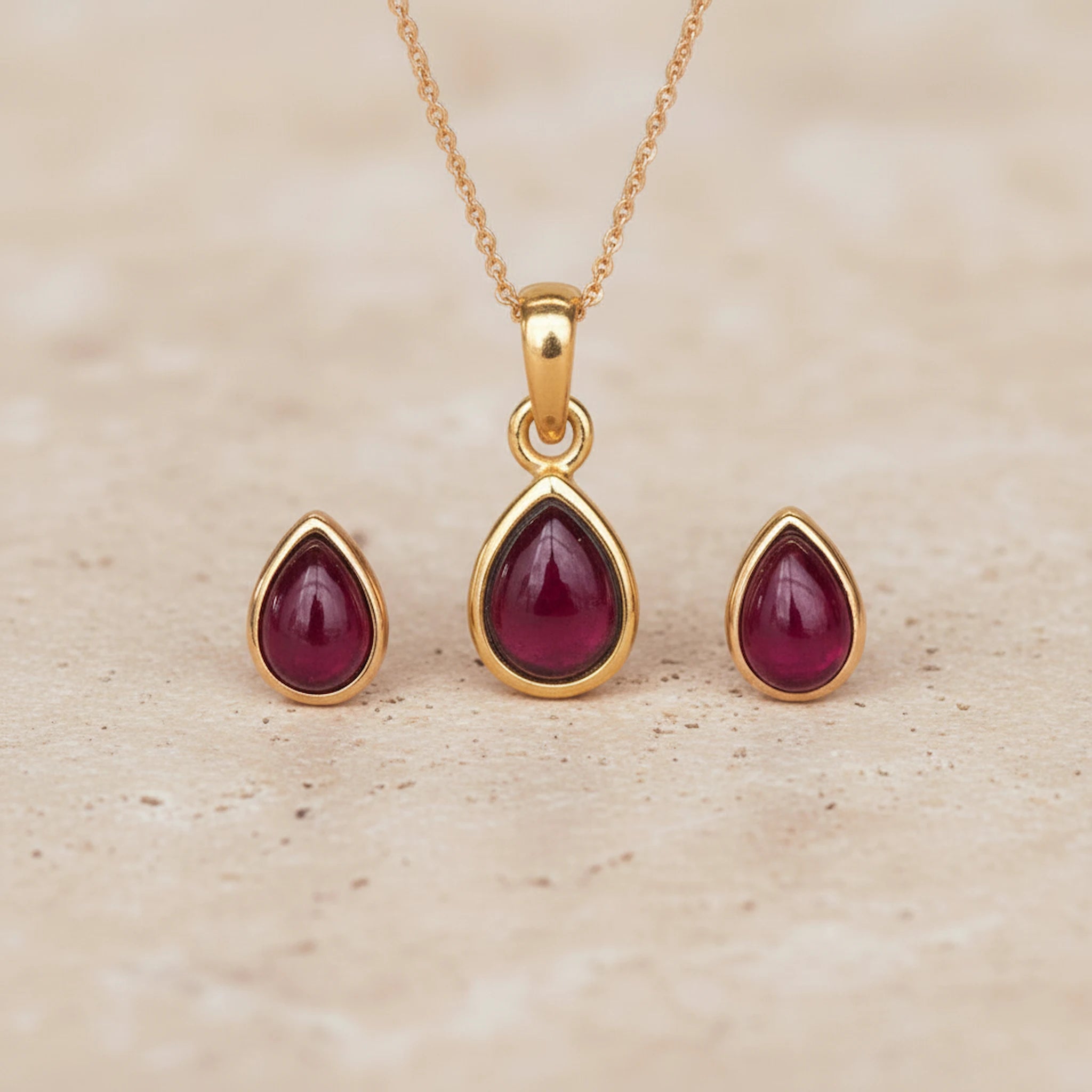 Gold January Birthstone Garnet Jewellery Set including pear-shaped Garnet stud earrings and pendant necklace