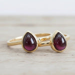 Two gold January birthstone garnet rings with teardrop garnet gemstones, Indie and Harper jewellery
