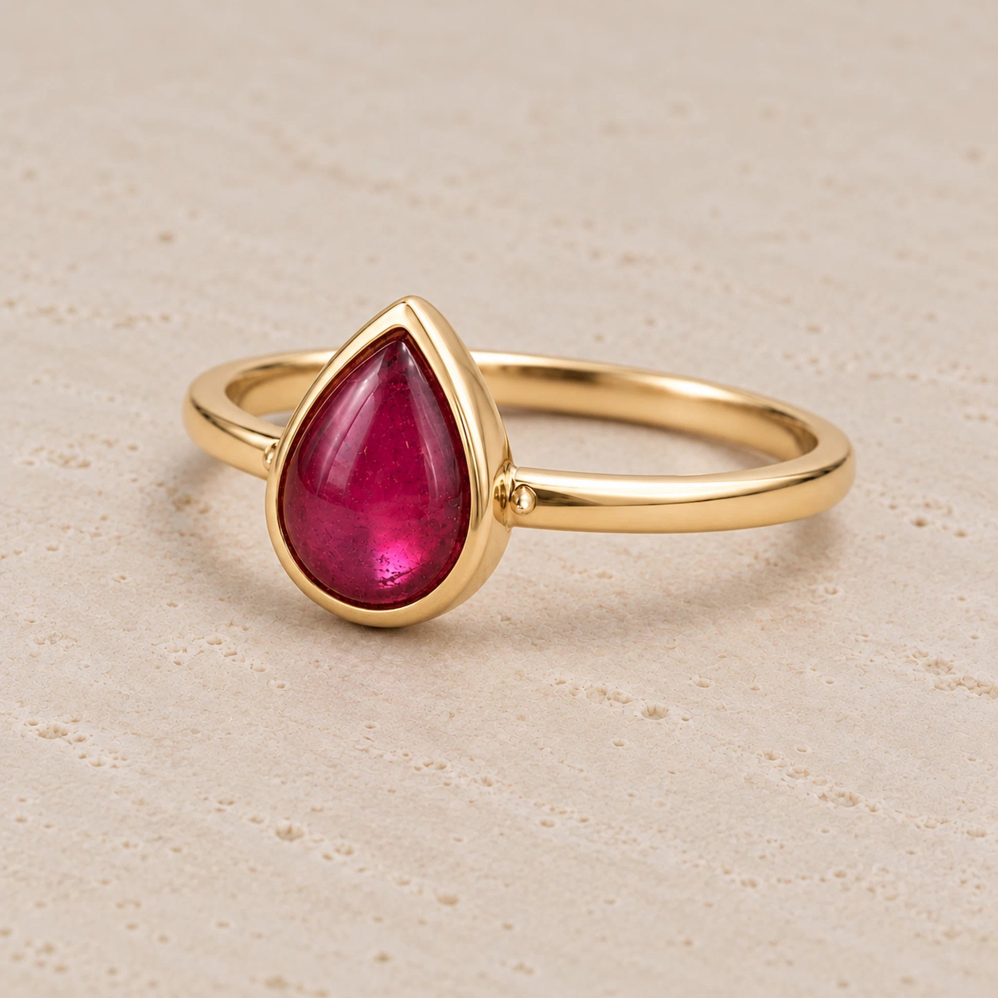 Gold July birthstone Ring with pear-shaped natural ruby gemstone as a meaningful birthday jewellery gift for her.