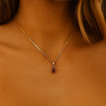 woman wearing a gold necklace with july birthstone ruby pendant by indie and harper australian jewellery