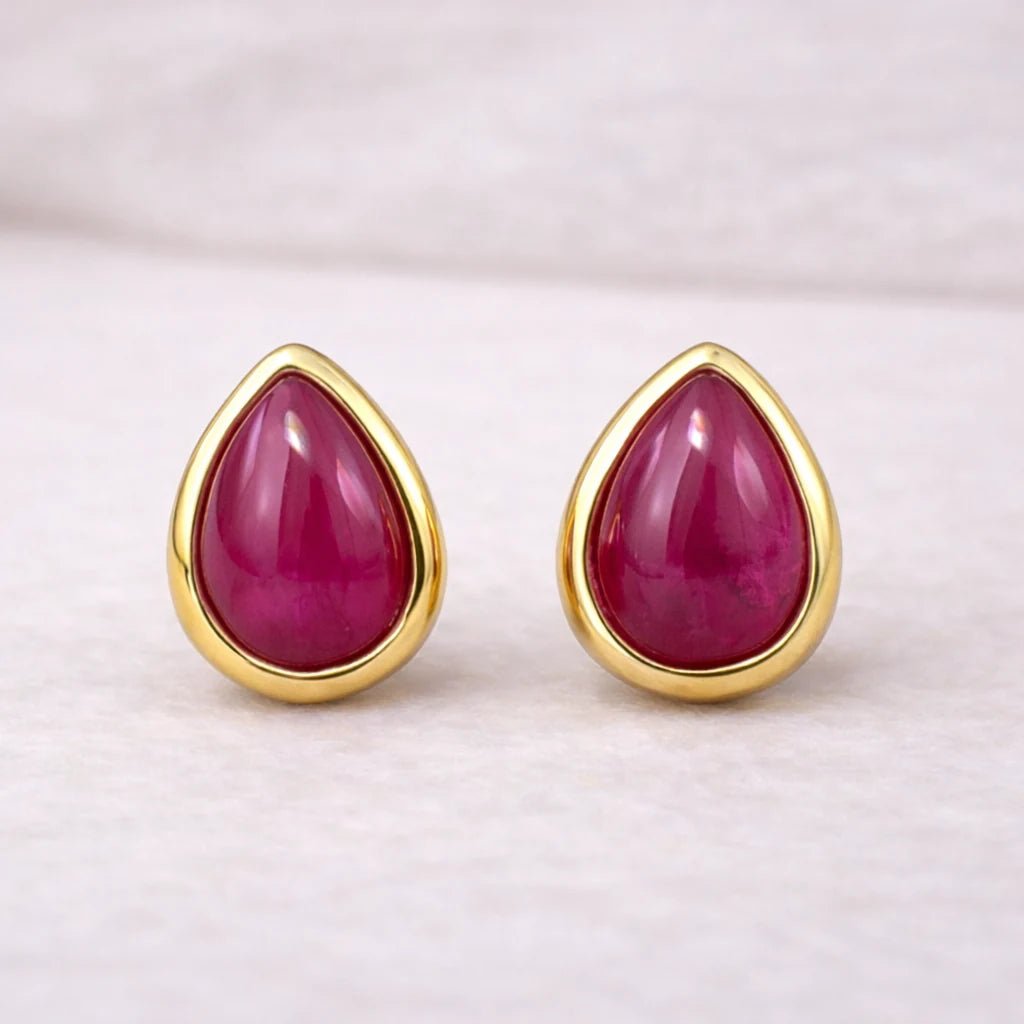 Gold July Birthstone stud earrings with pear-shaped natural ruby gemstones