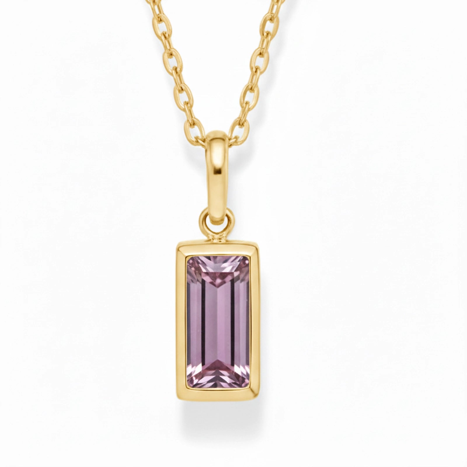Gold June Birthstone Necklace with pink cubic zirconia on a white background.