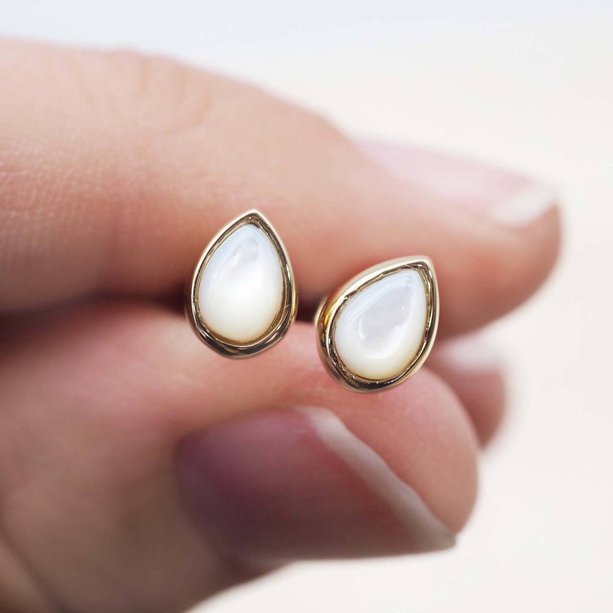 gold june birthstone mother of pearl earrings held - june birthday jewellery gift for her