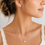 Gold June Birthstone Jewellery worn on a model, featuring a teardrop pendant pearl necklace and matching stud pearl earrings with natural milky white teardrop pearls