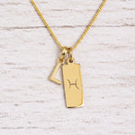 gold initial l pendant and pisces zodiac star sign pendant on a fine gold chain