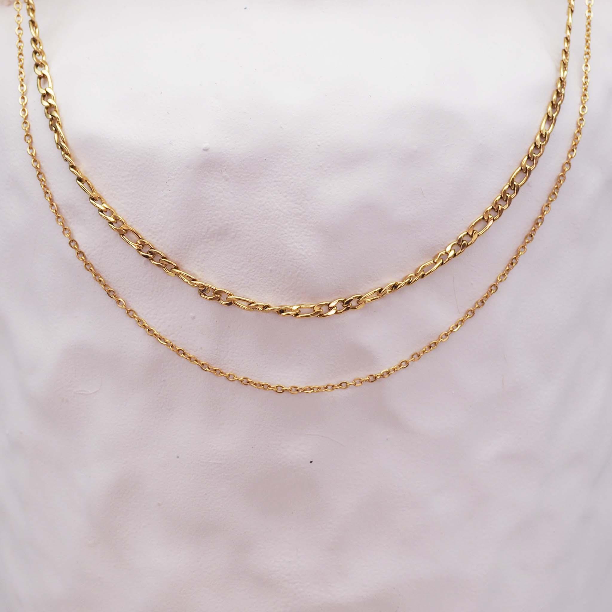 Gold chains necklace on a gray background