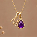 Gold initial M necklace with a natural February amethyst