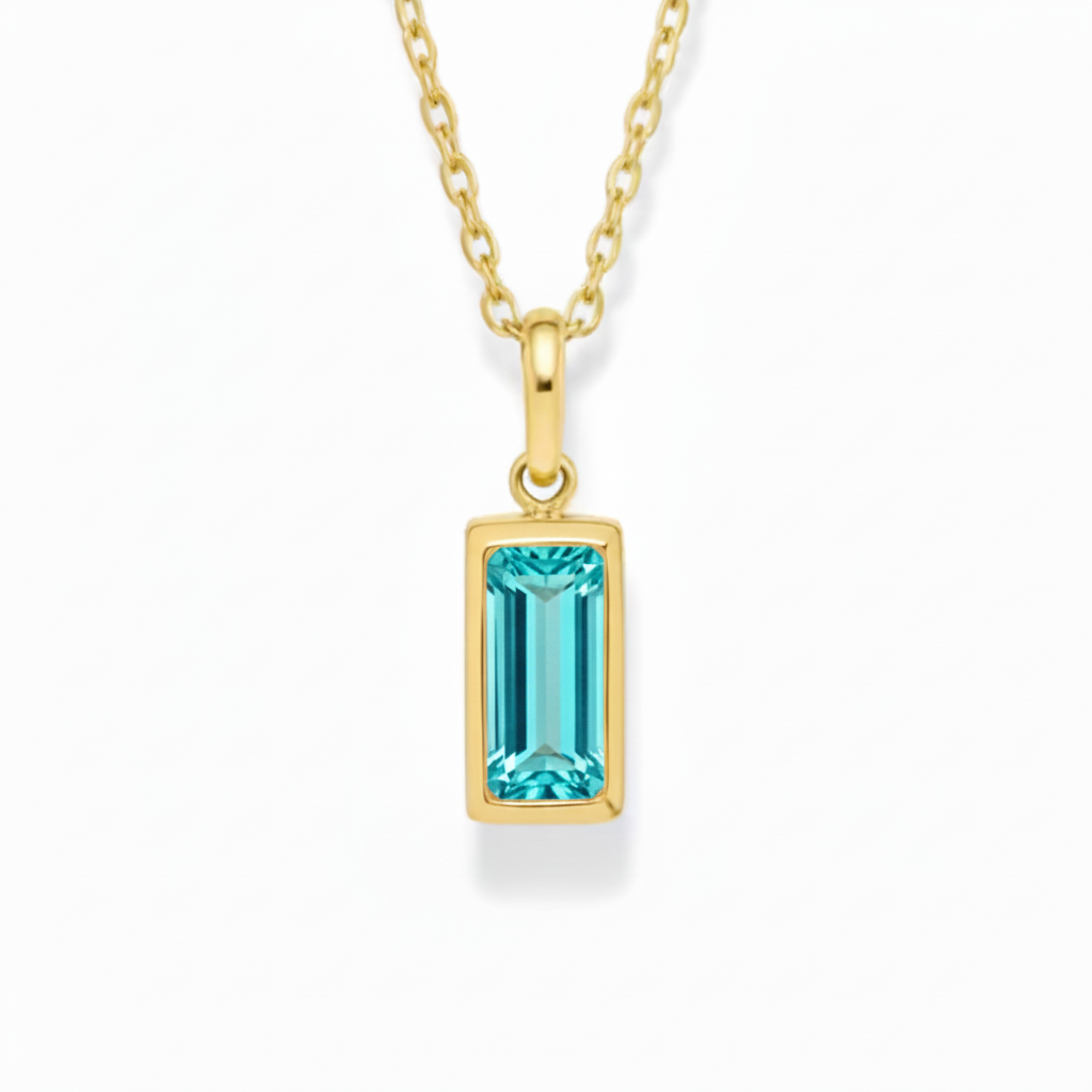 Gold necklace with a blue gemstone pendant on a white background