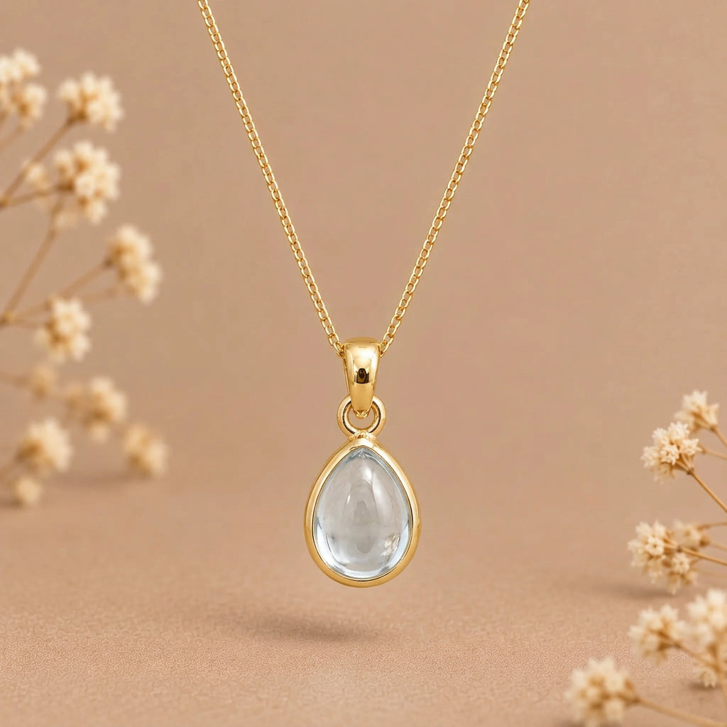 Gold March birthstone necklace with a teardrop bezel-set aquamarine pendant