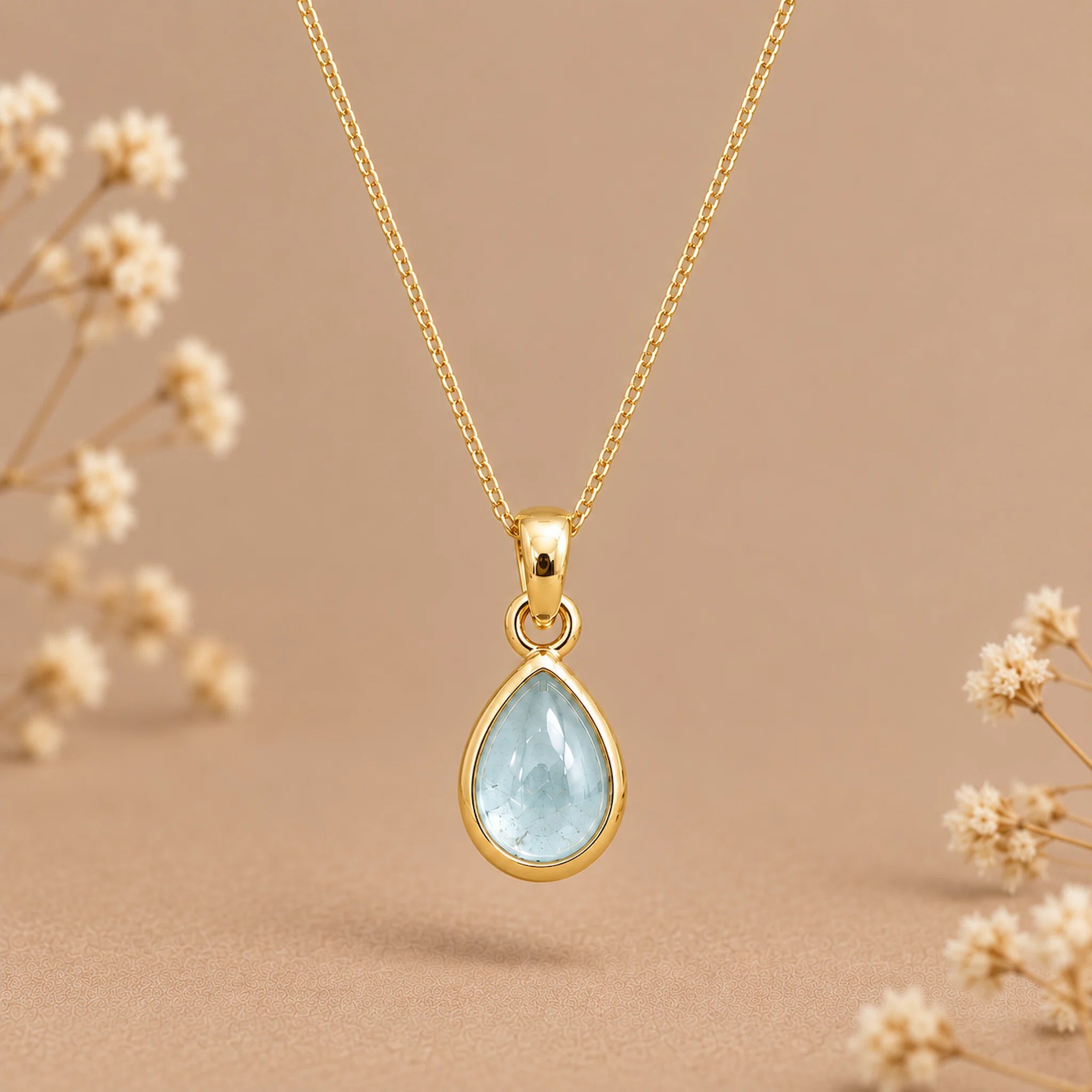 gold march birthstone necklace with teardrop bezel set cabochon natural aquamarine pendant