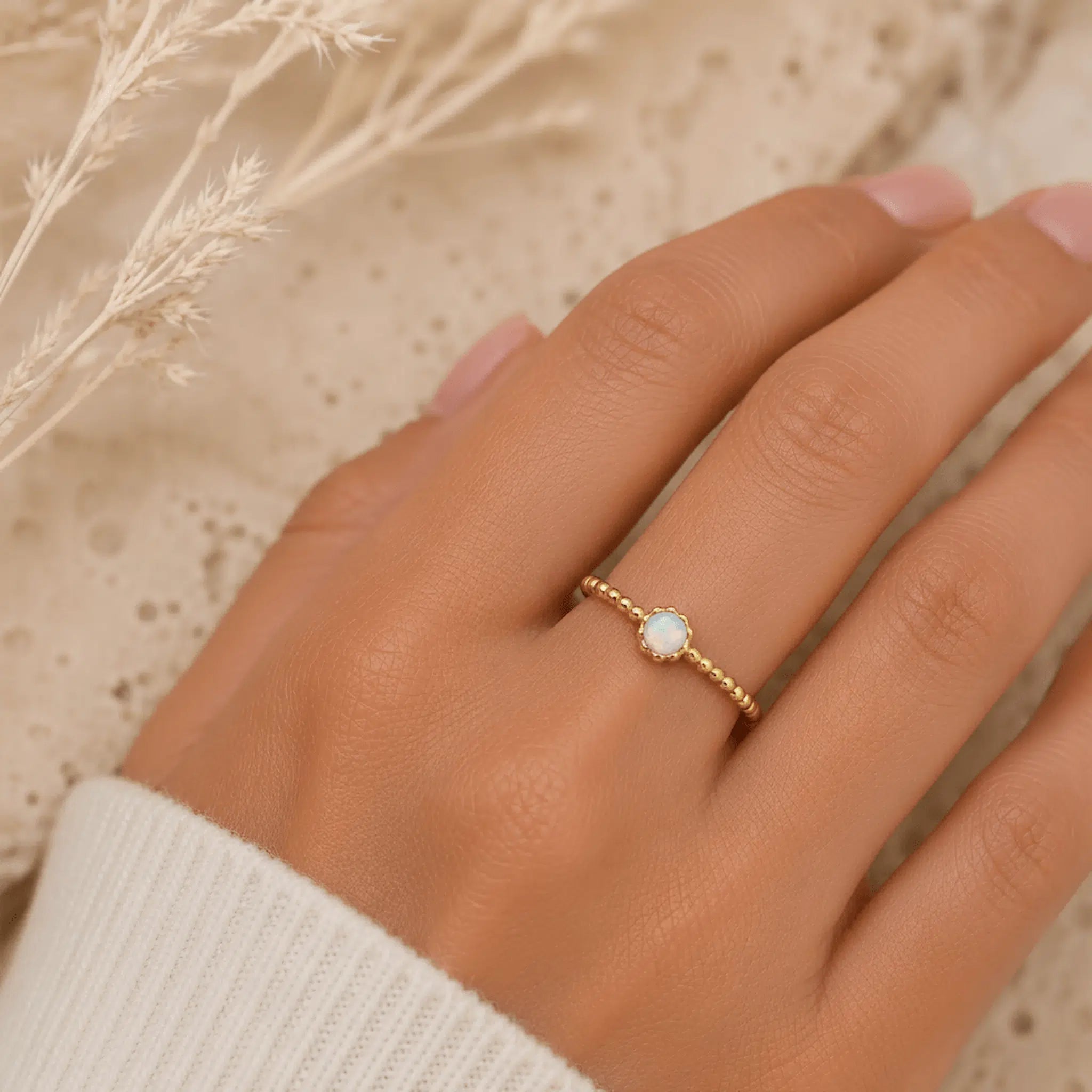 dainty gold white opal being worn 